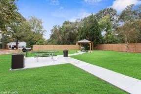 a park with a picnic table and a grill at Courthouse Green Apartments, Virginia