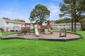 a playground is shown with a green grassy area at Courthouse Green Apartments, Virginia, 23832