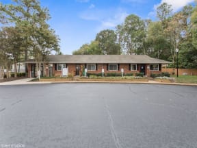a brick house with a parking lot in front of it at Courthouse Green Apartments, Chesterfield , VA 23832