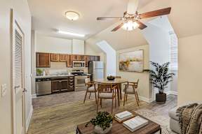 A modern kitchen with a dining table and chairs.