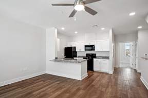 Grove Place I living room with a kitchen and a ceiling fan