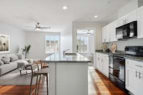 a kitchen with an island and a living room with a couch