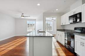 an empty kitchen with a counter top and a sink