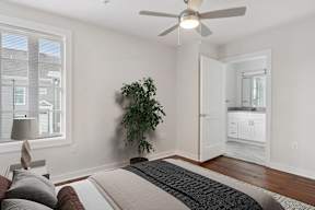 a bedroom with a bed and a ceiling fan