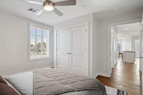 a bedroom with a bed and a ceiling fan
