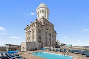 A large building with a pool in front of it.