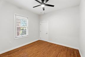 Grove Place II room with a ceiling fan and a window with blinds.