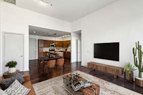 A modern living room with a flat screen TV on the wall.