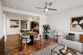 A modern living room with a dining table and chairs.