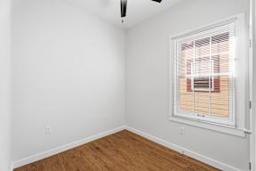 Grove Place II room with a window covered by blinds.