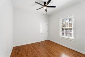 Grove Place II room with a ceiling fan and a window with blinds.