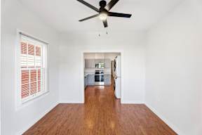 Grove Place II room with a ceiling fan and wooden flooring.
