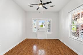 Grove Place II room with a ceiling fan and a window with blinds.
