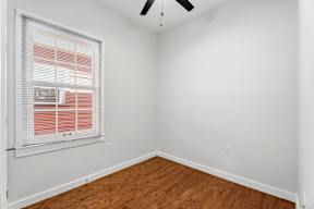 Grove Place II room with a window and a ceiling fan.