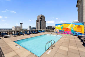 A large swimming pool with a mural on the wall.