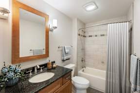 A bathroom with a sink, toilet, and bathtub.