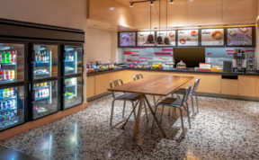 A modern kitchen with a wooden table and chairs.