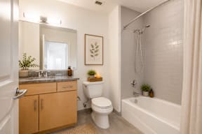 A bathroom with a toilet, sink, and bathtub.