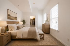 A bedroom with a large bed, nightstands, and a painting on the wall.