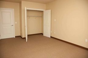 A room with a white door and a white closet door.