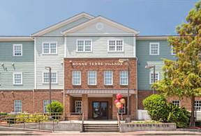 The front of a building with the name Bonne Terre Village on it.