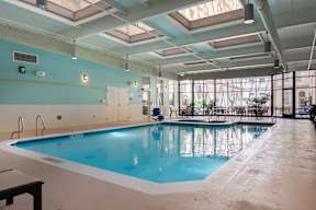 A large indoor swimming pool with a skylight above it.