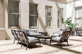 A patio with a table and chairs.