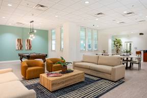 A living room with a sofa, armchairs, and a coffee table.
