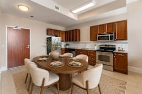 A modern kitchen with a dining table set for four.