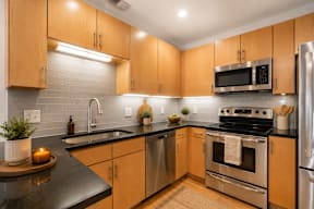 A modern kitchen with wooden cabinets and stainless steel appliances.