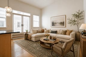 A living room with a couch, chair, and a coffee table.