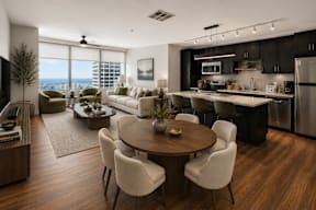 A modern kitchen with a dining table and chairs.