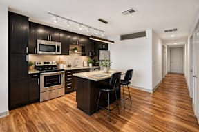A kitchen with dark wood cabinets and a center island.