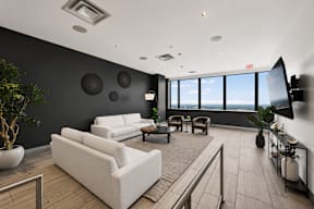 A modern living room with a large window overlooking the city.