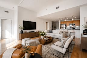 A modern living room with a brown leather couch and a white sofa.