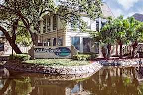 A sign that says Willowbrook in front of a building.