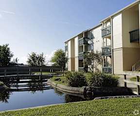 A building with a balcony overlooking a body of water.
