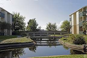A canal with a bridge and buildings on either side.
