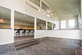A large open space with a dining area and a kitchen.