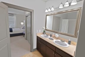 a bathroom with two sinks and a large mirror