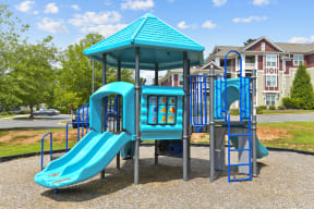 a playground with a swing set and a slide