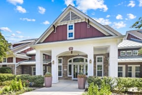 the exterior of a building with a porch and a pathway