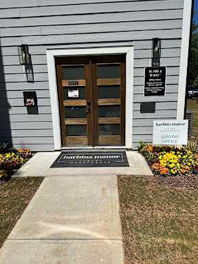 The front of a building with a sign that says Harbins Manor.