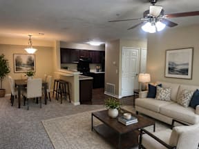 A living room with a couch, chairs, and a coffee table.