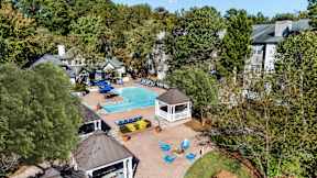 A pool surrounded by trees and a gazebo at The Point at Perimeter, Georgia, 30338