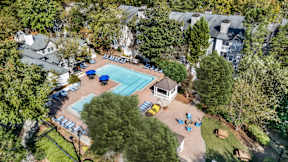 An aerial view of a swimming pool surrounded by trees and a small building. at The Point at Perimeter, Georgia, 30338