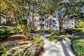 A park with a walking path and a bench. at The Point at Perimeter, Georgia, 30338