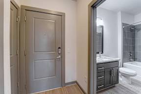 A bathroom with a toilet, sink, and shower.