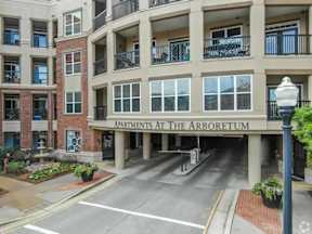 The Arboretum Apartments is a multi-story building with a parking lot in front.