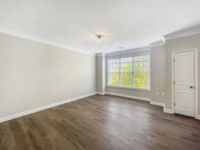 A room with a wooden floor and a white door.